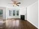 Bright living room with hardwood floors, fireplace, and lots of natural light from large windows at 120 Martingale Dr, Holly Springs, NC 27540