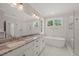 Bright bathroom with marble floors, soaking tub, and granite countertops on double vanity at 120 Pilot Ridge Rd, Zebulon, NC 27597