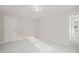 Minimalist bedroom featuring plush carpeting, natural light from a window, and a door for easy access at 120 Pilot Ridge Rd, Zebulon, NC 27597