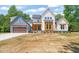 Stunning two-story home featuring mixed siding, a two-car garage and pristine landscaping at 120 Pilot Ridge Rd, Zebulon, NC 27597