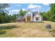 Stunning two-story home featuring a well-manicured lawn, custom garage and driveway at 120 Pilot Ridge Rd, Zebulon, NC 27597