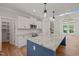 Open concept kitchen with modern appliances, granite countertops, and an island with pendant lighting at 120 Pilot Ridge Rd, Zebulon, NC 27597