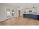 Bright and airy kitchen with a blue center island, white cabinets, and access to the outdoor patio at 120 Pilot Ridge Rd, Zebulon, NC 27597