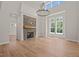 Spacious living room with stone fireplace, hardwood floors, and plenty of natural light at 120 Pilot Ridge Rd, Zebulon, NC 27597