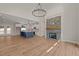 Open-concept living space with a kitchen island, stone fireplace, and hardwood floors at 120 Pilot Ridge Rd, Zebulon, NC 27597