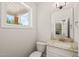 Well-lit powder room with granite vanity top and view through the window at 120 Pilot Ridge Rd, Zebulon, NC 27597