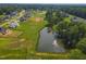 Aerial view of the community pond featuring a fountain and beautiful landscaping at 1212 Perry Bluff Dr, Wake Forest, NC 27587