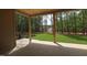 Covered back porch with tiled floor and a view of a wooded backyard at 1212 Perry Bluff Dr, Wake Forest, NC 27587