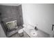 Modern bathroom with gray tile, sleek fixtures, and vanity with marble counter at 1212 Perry Bluff Dr, Wake Forest, NC 27587