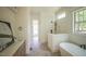 Bright bathroom featuring a soaking tub, tiled shower and tile floors at 1212 Perry Bluff Dr, Wake Forest, NC 27587