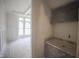 A butler's pantry with light walls and light marble countertops is under construction with protective plastic coverings at 1212 Perry Bluff Dr, Wake Forest, NC 27587