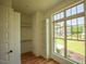 Walk-in closet with custom shelving and window overlooking landscaped yard at 1212 Perry Bluff Dr, Wake Forest, NC 27587
