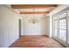 Bright dining room with wood floors, decorative wood beams, and a chandelier at 1212 Perry Bluff Dr, Wake Forest, NC 27587