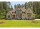 Beautiful two-story home with a stone and siding exterior and manicured lawn at 1212 Perry Bluff Dr, Wake Forest, NC 27587