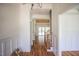Hallway featuring hardwood floors and a view of the stairway and living area at 1212 Perry Bluff Dr, Wake Forest, NC 27587