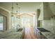 Open-concept kitchen with a marble countertop, a gas range, and stylish lighting at 1212 Perry Bluff Dr, Wake Forest, NC 27587