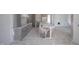 The kitchen features light cabinets, marble countertops, and an island, still under construction with protective plastic coverings at 1212 Perry Bluff Dr, Wake Forest, NC 27587