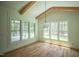 Bright living area with hardwood floors, decorative wood beams, and large windows at 1212 Perry Bluff Dr, Wake Forest, NC 27587