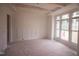 An unfinished living room features white walls and unfinished wood beams, and large windows at 1212 Perry Bluff Dr, Wake Forest, NC 27587