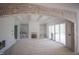 Bright living room with a fireplace and built-in shelves is under construction with protective plastic coverings at 1212 Perry Bluff Dr, Wake Forest, NC 27587