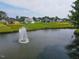 Community pond features a fountain, grassy surround, and neighborhood homes at 1212 Perry Bluff Dr, Wake Forest, NC 27587