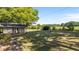 House with a large backyard and a screened-in porch; yard features large trees at 129 Castle Dr, Smithfield, NC 27577