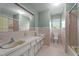 Vintage bathroom with mint green walls, tiled floors, and double vanity sinks at 129 Castle Dr, Smithfield, NC 27577