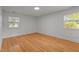 Bright, spacious bedroom with hardwood floors and ample natural light from two windows at 129 Castle Dr, Smithfield, NC 27577