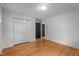 Spacious bedroom with closet, connecting door, and gleaming hardwood floors at 129 Castle Dr, Smithfield, NC 27577
