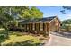 Attractive brick home features an attached garage and mature trees, adding to its overall appeal at 129 Castle Dr, Smithfield, NC 27577