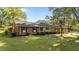 Landscaped single-story brick home featuring a well-maintained lawn and classic architectural details at 129 Castle Dr, Smithfield, NC 27577