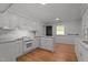 Bright kitchen features white cabinets, granite countertops, and stainless steel oven at 129 Castle Dr, Smithfield, NC 27577