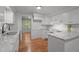 Bright kitchen featuring white cabinets, granite counters, subway tile backsplash and stainless steel sink at 129 Castle Dr, Smithfield, NC 27577