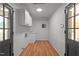Functional laundry room with cabinet storage, utility sink, and easy outdoor access at 129 Castle Dr, Smithfield, NC 27577