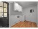 Convenient laundry room with cabinets, utility sink, and access door at 129 Castle Dr, Smithfield, NC 27577
