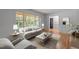 Bright living room with natural light, stylish furniture, and hardwood floors offers a comfortable space at 129 Castle Dr, Smithfield, NC 27577