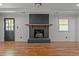 Spacious living room featuring hardwood floors and a fireplace with a wooden mantel at 129 Castle Dr, Smithfield, NC 27577