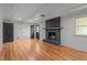 Spacious living room featuring wood-look floors and black brick fireplace at 129 Castle Dr, Smithfield, NC 27577