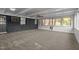 Bright sunroom with a wall of windows and carpet flooring at 129 Castle Dr, Smithfield, NC 27577