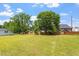 Large backyard with a wooden fence, mature trees, and green grass at 1325 Sweetclover Dr, Wake Forest, NC 27587