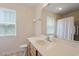 Well-lit bathroom features a single vanity, tile flooring, and a large mirror at 1325 Sweetclover Dr, Wake Forest, NC 27587