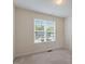 Bright bedroom featuring carpeted floors and a large window offering lots of natural light at 1325 Sweetclover Dr, Wake Forest, NC 27587