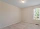 Empty bedroom has carpeted floors and a bright window for lots of natural light at 1325 Sweetclover Dr, Wake Forest, NC 27587