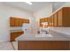 Bright kitchen featuring tiled floors, grey counters, and wood cabinets at 1325 Sweetclover Dr, Wake Forest, NC 27587