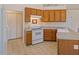 This kitchen has tiled floors, grey counters, and wood cabinets at 1325 Sweetclover Dr, Wake Forest, NC 27587