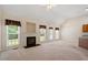 Spacious living area with fireplace, windows, and modern lighting at 1325 Sweetclover Dr, Wake Forest, NC 27587