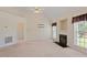 Cozy living room with fireplace, ceiling fan, and ample natural light at 1325 Sweetclover Dr, Wake Forest, NC 27587