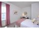 Cozy bedroom featuring a large window, decorative accents, and a comfortable bed with plush bedding at 134 Beacon Dr, Pittsboro, NC 27312