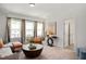 Cozy bonus room with neutral decor, plush seating, and bright natural light from the windows at 134 Beacon Dr, Pittsboro, NC 27312