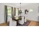 Dining room with a dark wood table, upholstered chairs, and a patterned rug, creating an inviting atmosphere at 134 Beacon Dr, Pittsboro, NC 27312